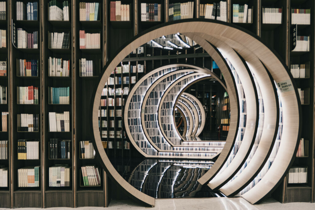 Panoramic view of modern library with round bookshelf and illuminated circular arches background Wallpaper