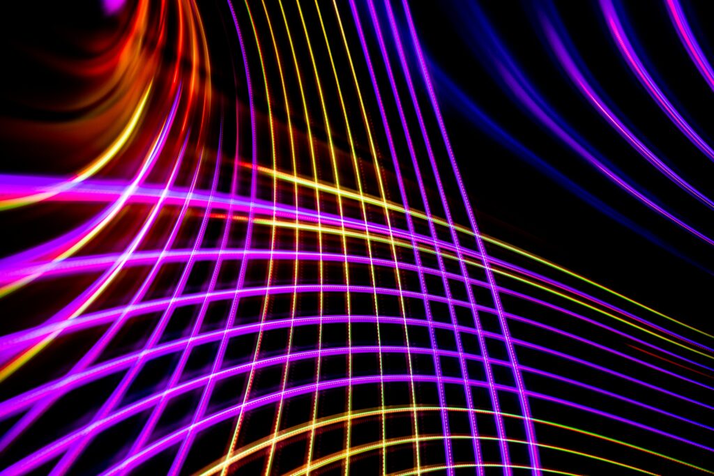 Vibrant Abstract Neon Light Trails Wallpaper in Purple, Yellow, Blue