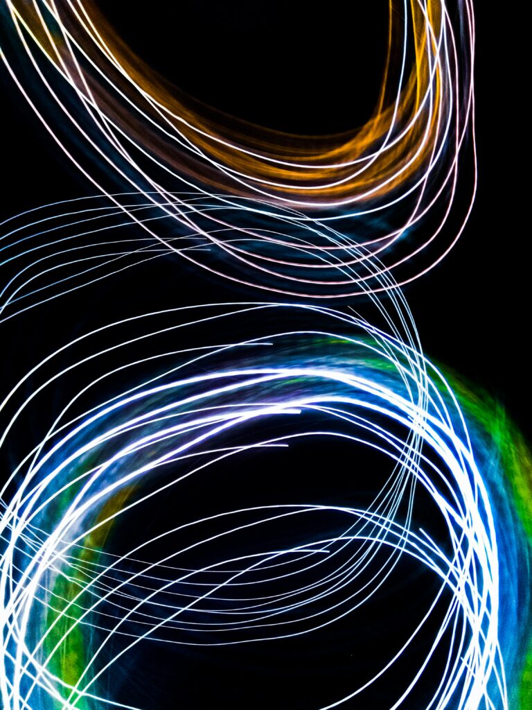 Vibrant Neon Light Wallpaper: Mesmerizing Circles on Black Background