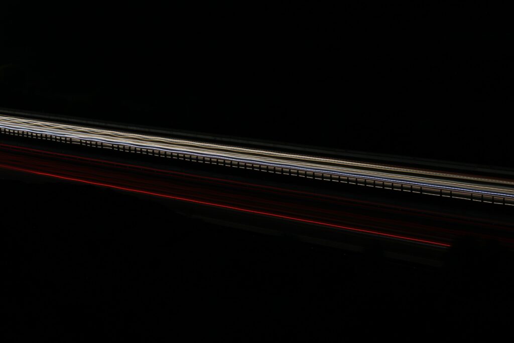 Neon Light Streaks Wallpaper: Long Exposure Art on Dark Background