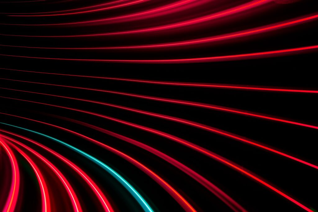 Vibrant Neon Light Stripes Abstract Wallpaper on Dark Background
