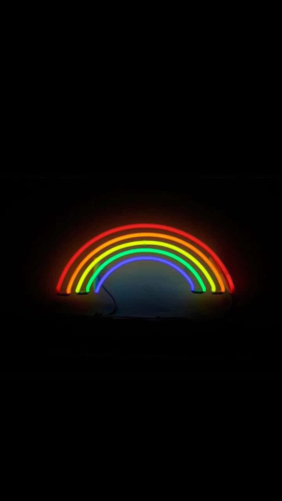 Vibrant neon rainbow arc on black background minimalist aesthetic wallpaper for modern screens