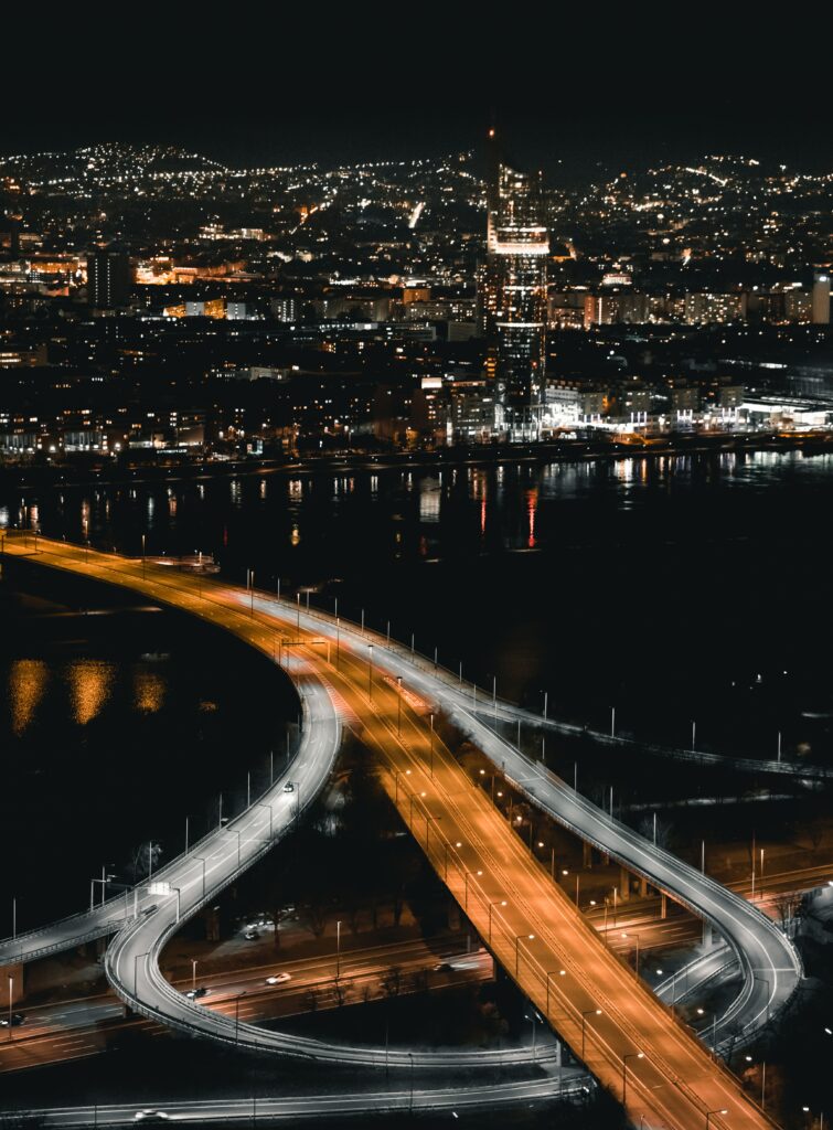 Stunning Night Cityscape Wallpaper: Aerial Road with Glowing Lights