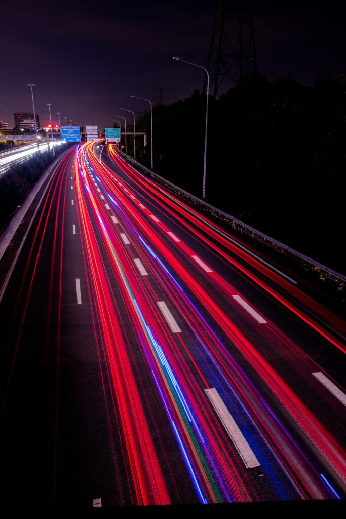 Vibrant Night Highway Wallpaper: Red & Blue Light Trails Background