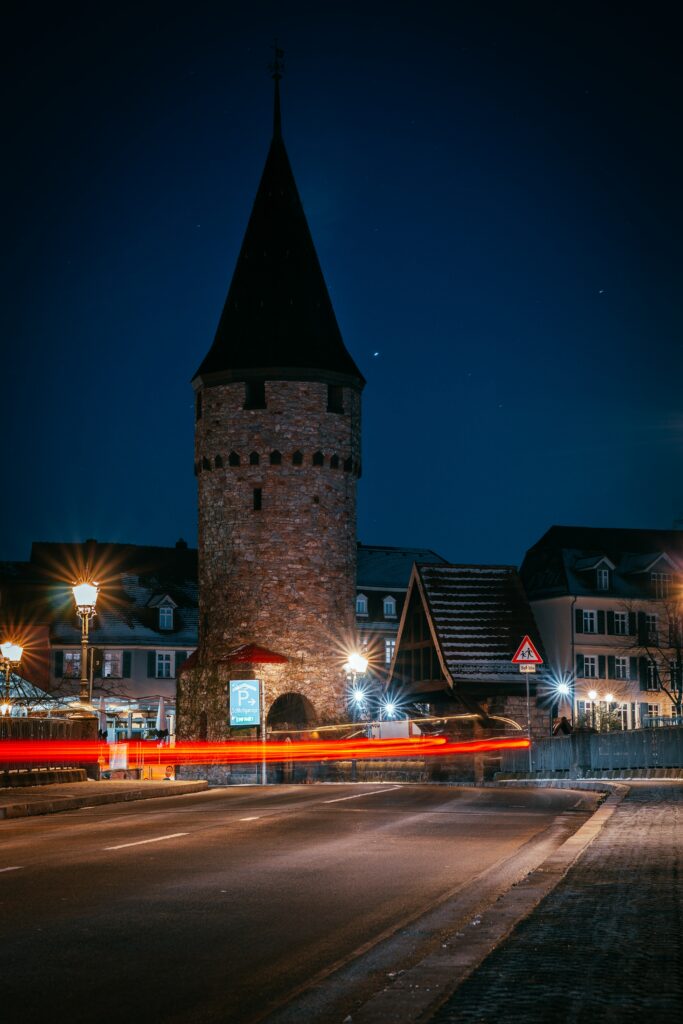 Enchanting Nighttime Wallpaper of an Illuminated Stone Tower