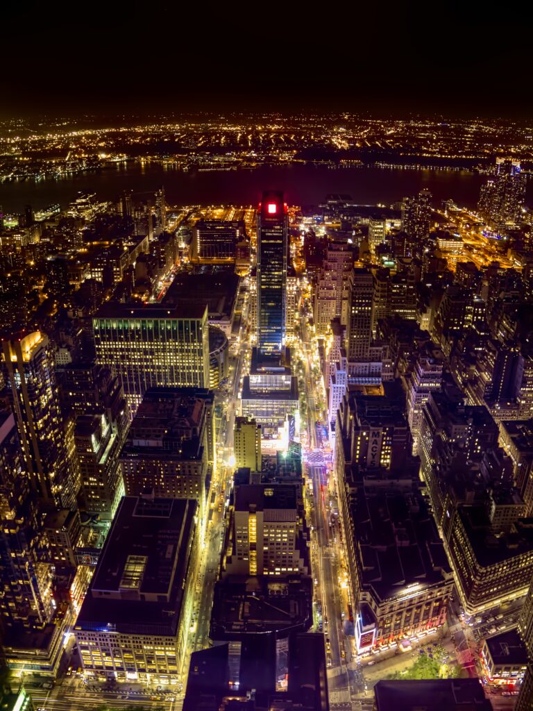Vibrant City Nightscape Wallpaper: Glowing Lights & Serene River