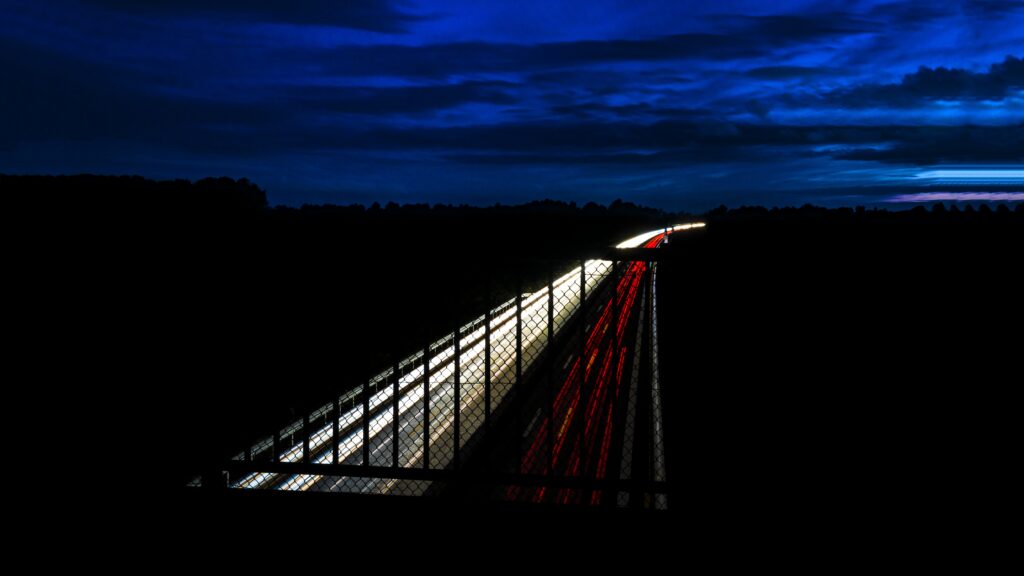 Mesmerizing Nighttime Highway Wallpaper with Vibrant Light Trails