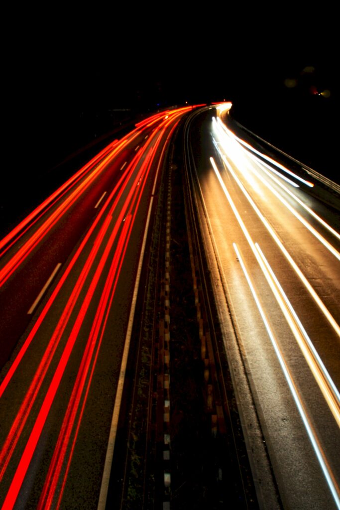 Mesmerizing Nighttime Road Wallpaper: Vibrant Light Trails