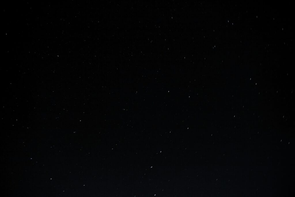 Mesmerizing Outer Space Wallpaper with Glowing Stars Background