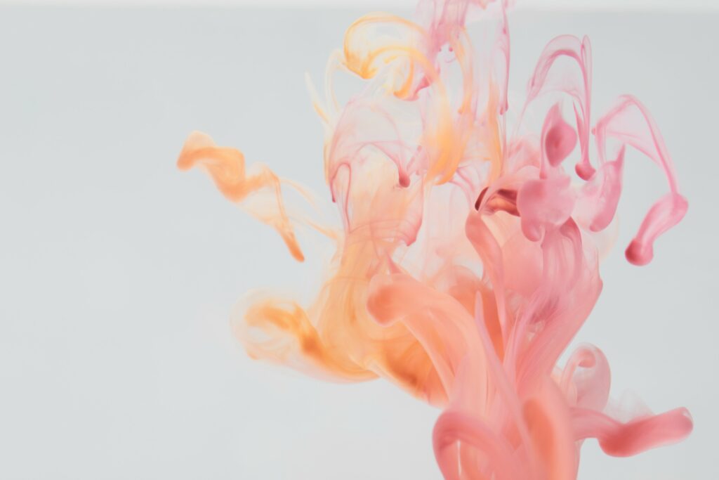 Mesmerizing Pink & Orange Ink Wallpaper Background in Liquid