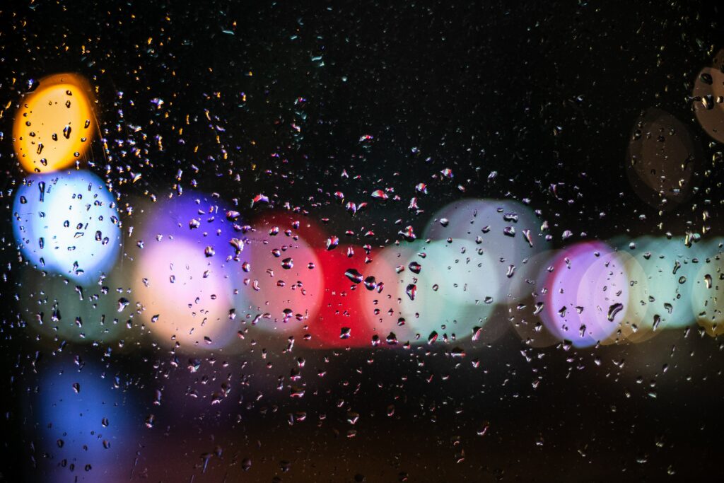 Serene Raindrop Wallpaper: Blurred Bokeh Lights Background