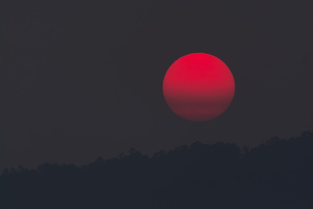 Red Eclipse Wallpaper: Serene Mountain Silhouette Against Dark Sky