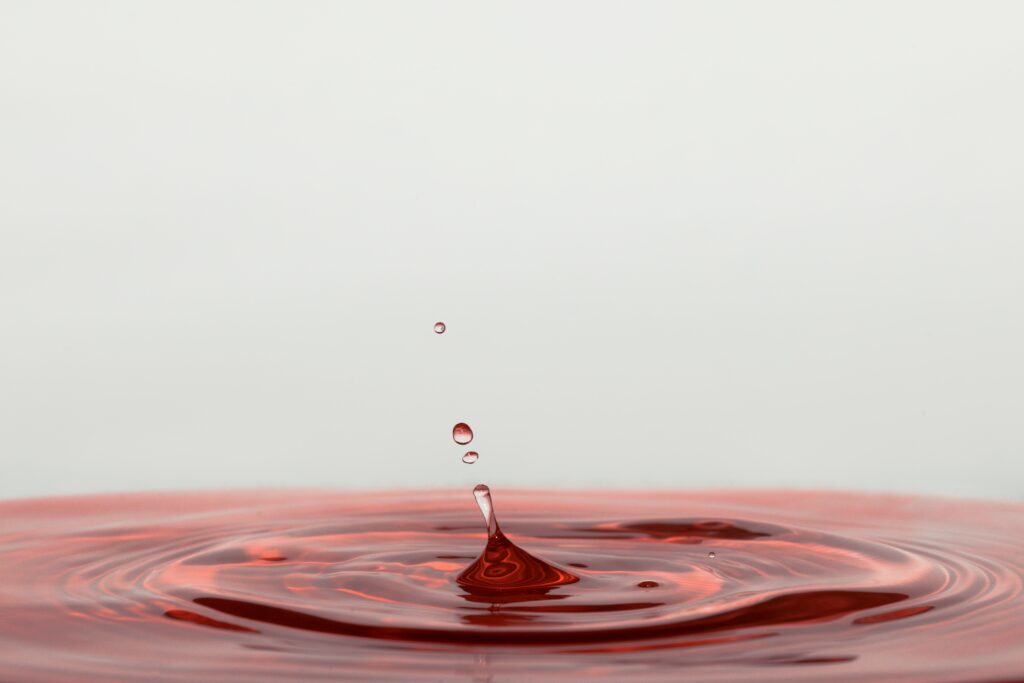 Captivating Red Liquid Splash Wallpaper - Mesmerizing Background