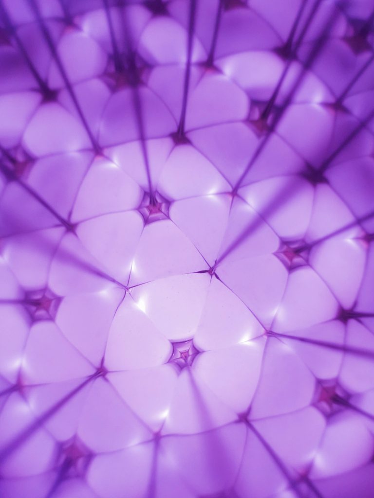 Abstract purple kaleidoscope wallpaper with glowing hexagon shapes and geometric patterns background