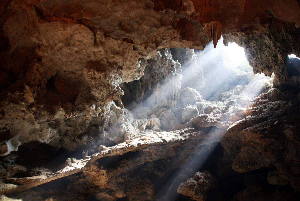 Mesmerizing Cave Stalactites: Illuminated Rocky Background Wallpaper