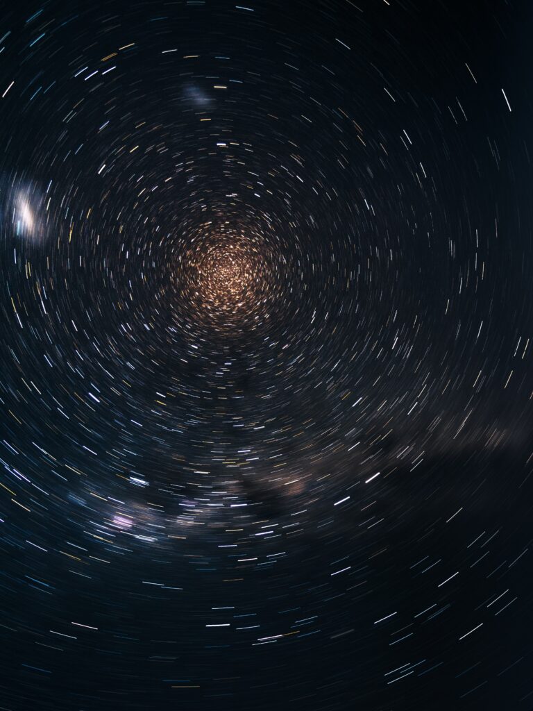Mesmerizing Starry Sky Wallpaper with Abstract Rotational Blur