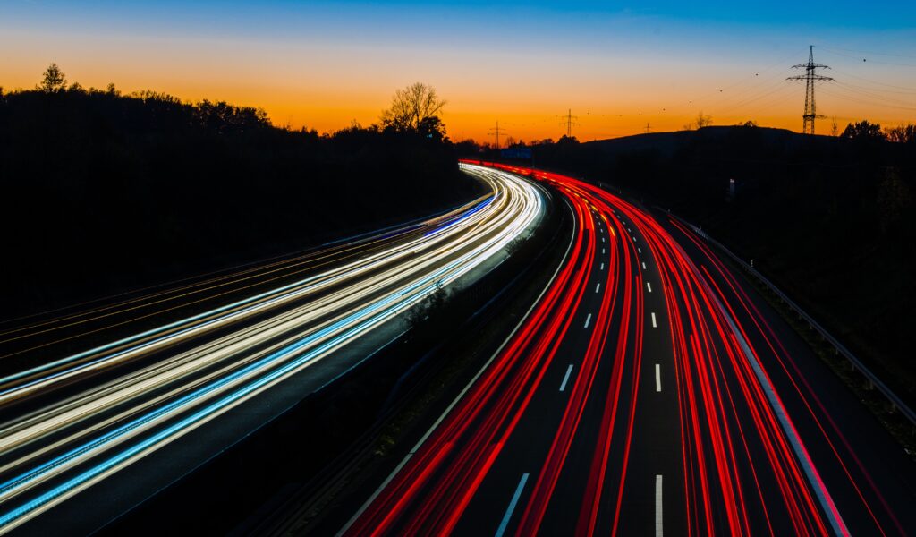 Mesmerizing Twilight Road Wallpaper with Light Trails & Scenic Sky