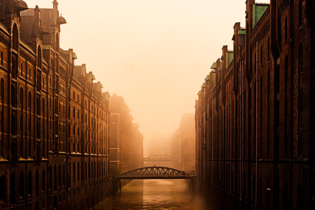 Mesmerizing Urban Canal Wallpaper: Historic Buildings & Golden Fog