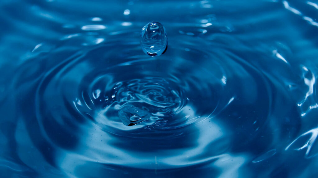 Mesmerizing Water Drop Wallpaper: Tranquil Blue Ripples Background