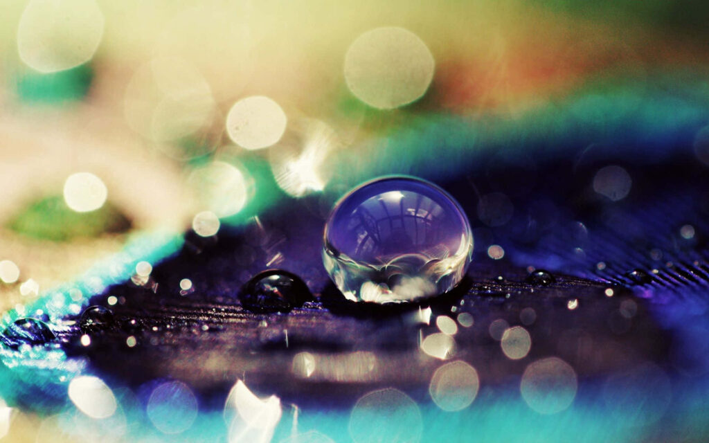 Stunning Water Droplet on Colorful Surface - Ethereal Background Wallpaper
