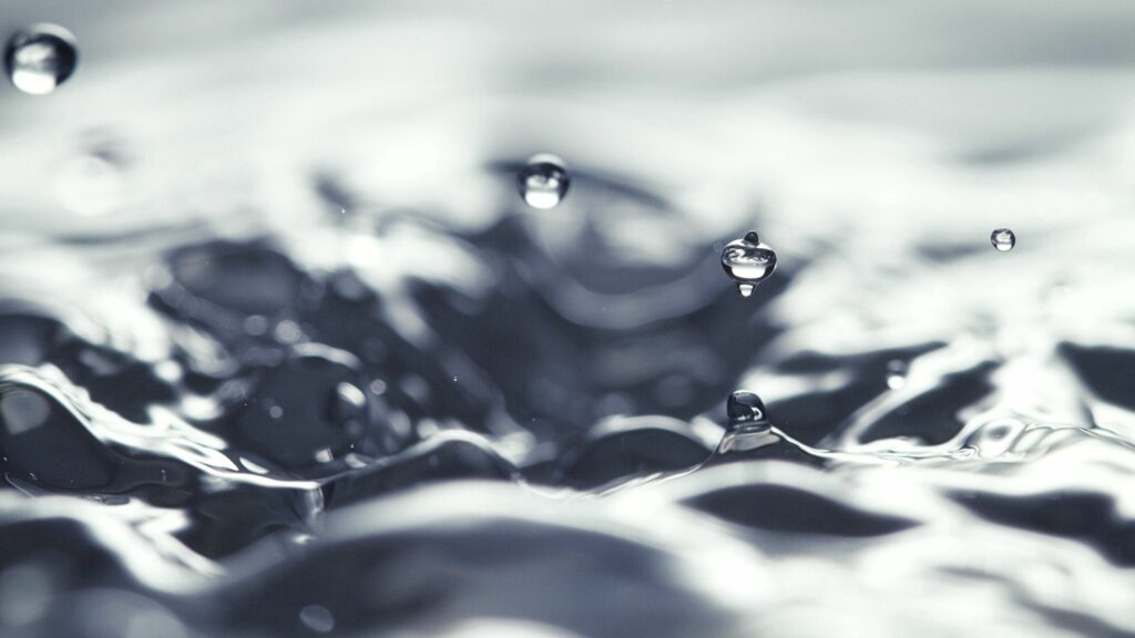 Mesmerizing Water Droplets Wallpaper: Serene Spray Background