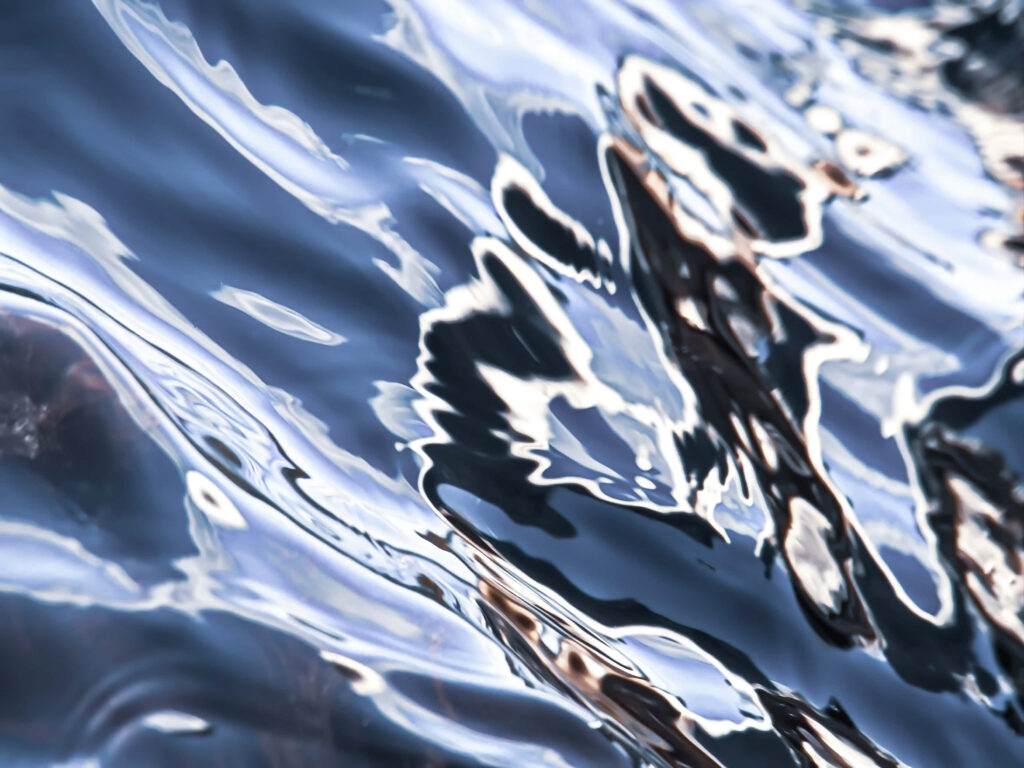 Captivating Rippling Water Wallpaper: Tranquil Light & Dark Patterns