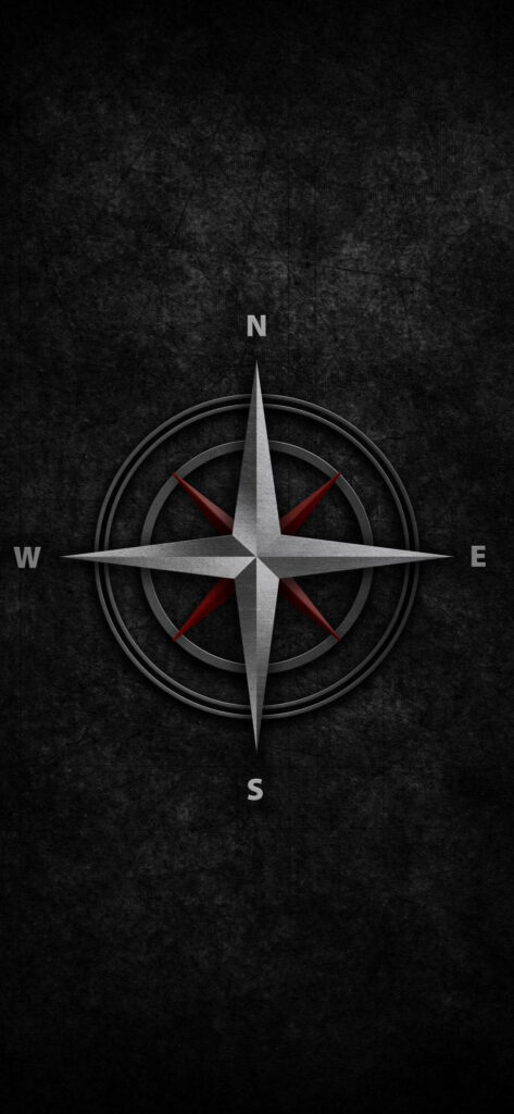 Metallic compass rose with red and white accents on dark textured background wallpaper