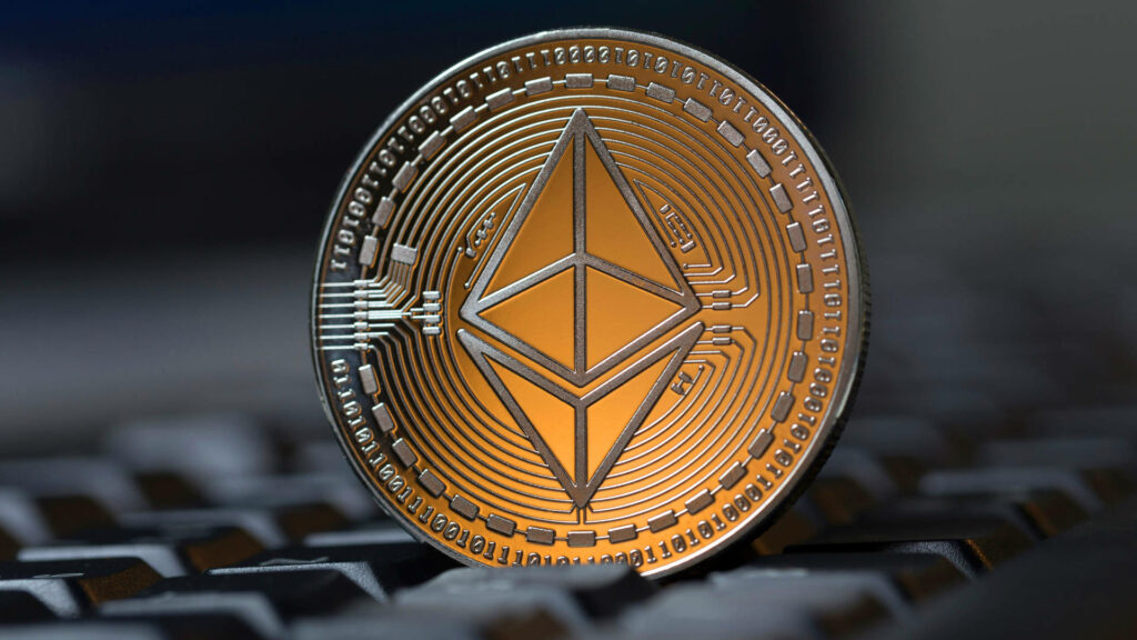 Metallic Ethereum coin with circuit design on blurred keyboard symbolizing blockchain tech Wallpaper