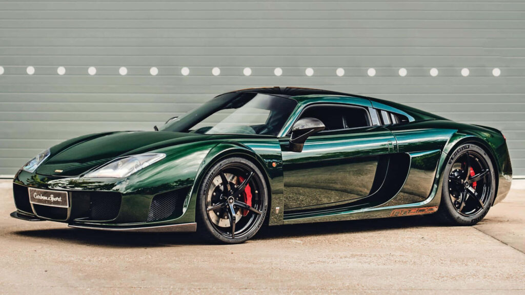 Metallic green Noble sports car with sleek aerodynamic design on clean neutral background Wallpaper