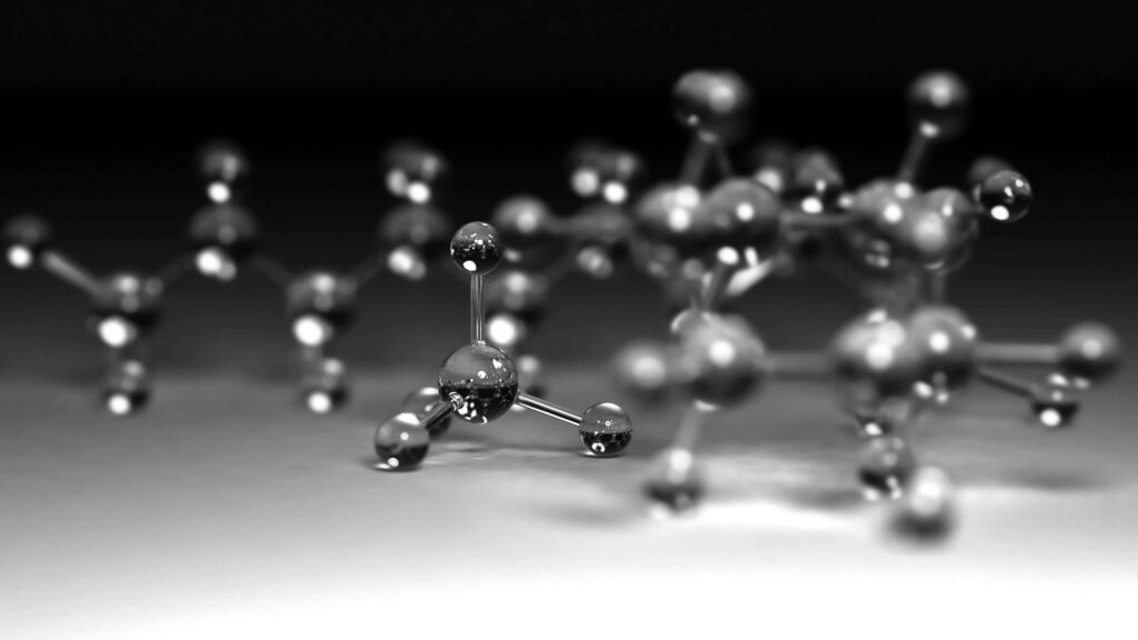 Close-up of sleek metallic molecular structures on monochrome gradient chemistry wallpaper background