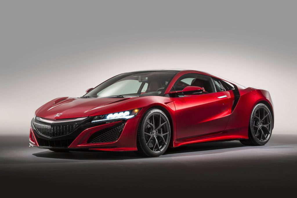 Metallic red Honda NSX supercar with aerodynamic curves and LED headlights in studio backdrop Wallpaper