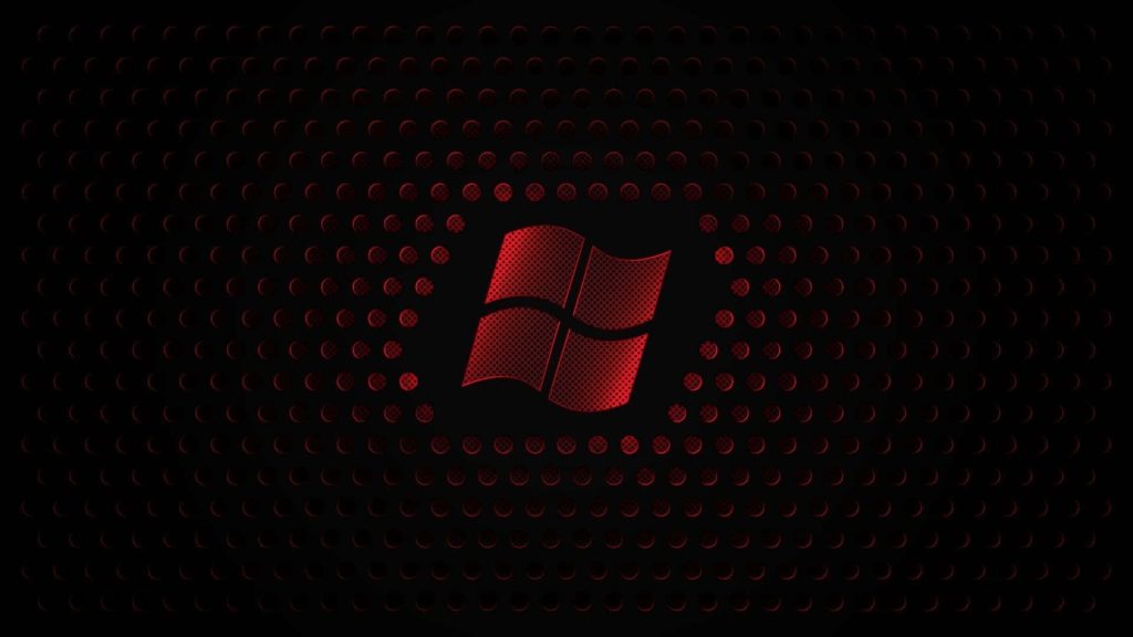 Metallic glowing red Windows logo on black perforated mesh background gaming wallpaper
