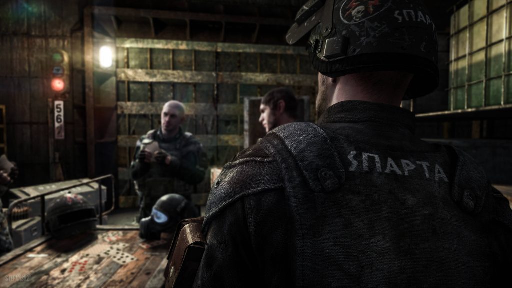 Sparta Ranger watches teammates play cards in dim post-apocalyptic Metro Last Light bunker Wallpaper