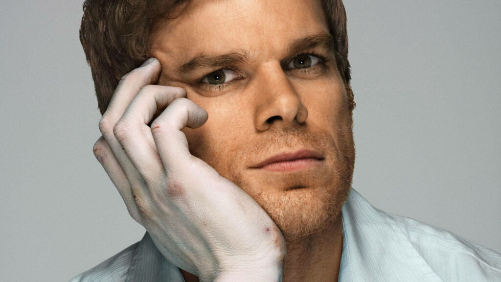 Michael C Hall as Dexter Morgan close-up intense gaze pale hand gray background wallpaper