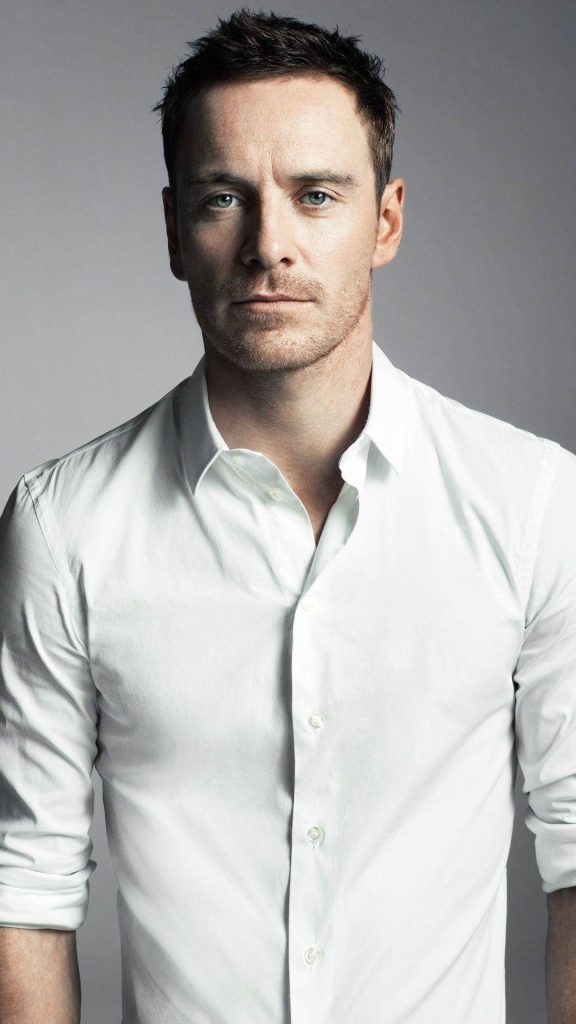Michael Fassbender intense gaze studio portrait white shirt gray background soft lighting Wallpaper