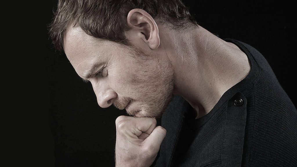Michael Fassbender contemplative profile portrait dramatic lighting black background wallpaper