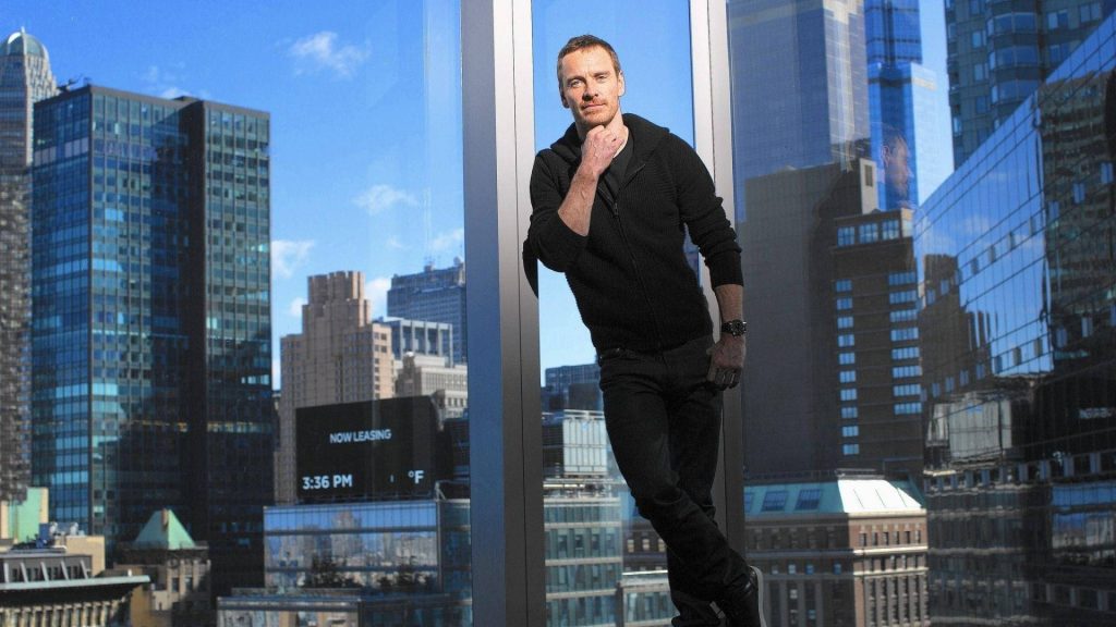 Michael Fassbender by window with skyscrapers clear sky urban sophisticated desktop wallpaper