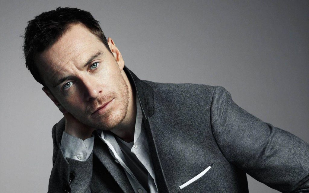 Michael Fassbender in grey blazer white shirt intense gaze studio portrait wallpaper background