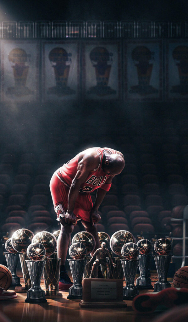 The Iconic Michael Jordan Reveres His Triumphs in the Solitude of an Enthralling Sports Arena Wallpaper