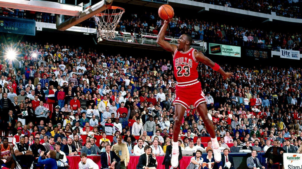 Michael Jordan's Jaw-Dropping Vertical Leap: A High-Definition Encounter with Basketball Greatness Wallpaper
