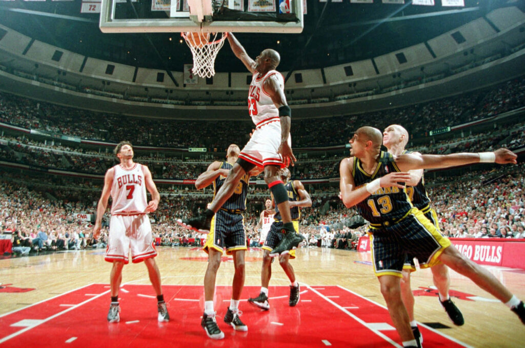 Airborne Legend: Michael Jordan Defying Gravity in his Prime Wallpaper