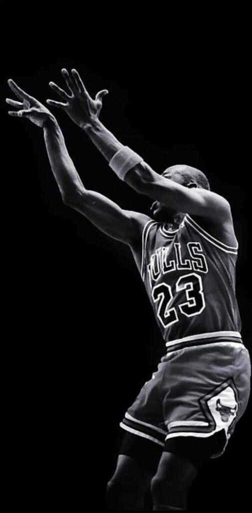 The Iconic Michael Jordan Slamming the Ball: A Striking Black and White Basketball Portrait Wallpaper