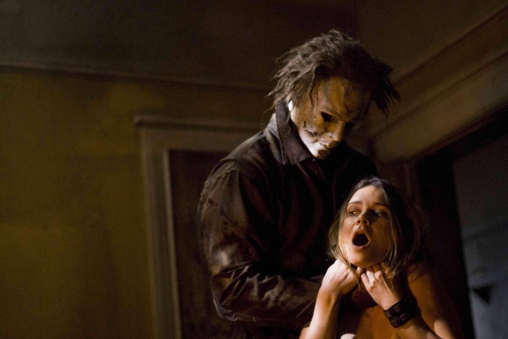 Michael Myers choking victim in dark intense horror scene from Rob Zombie Halloween II wallpaper
