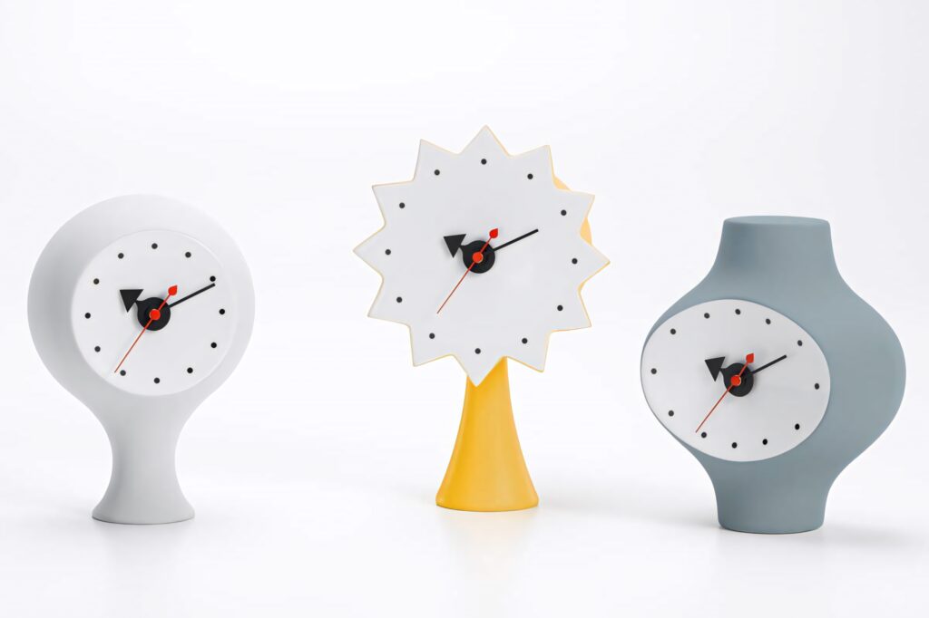 George Nelson ceramic 3D clocks trio mid-century modern sculptural white yellow gray tones wallpaper
