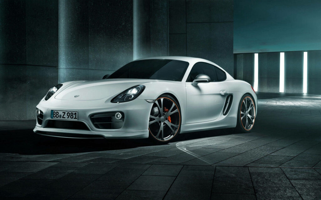 Nightly Elegance: Capturing the Stunning White Porsche Cayman S in a Well-Lit Garage Wallpaper