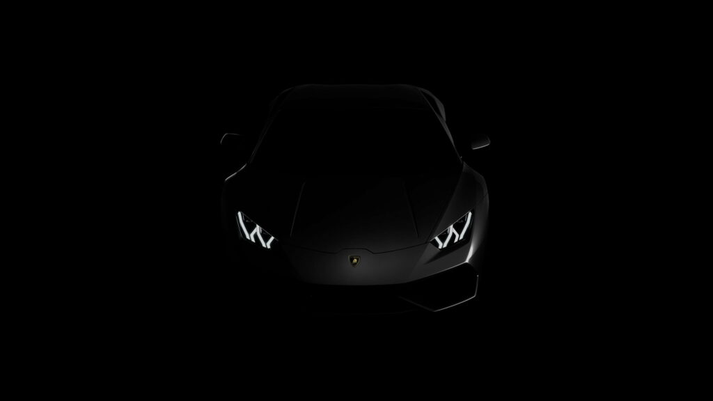 Black Lamborghini QHD wallpaper with dramatic lighting and sleek silhouette on dark background