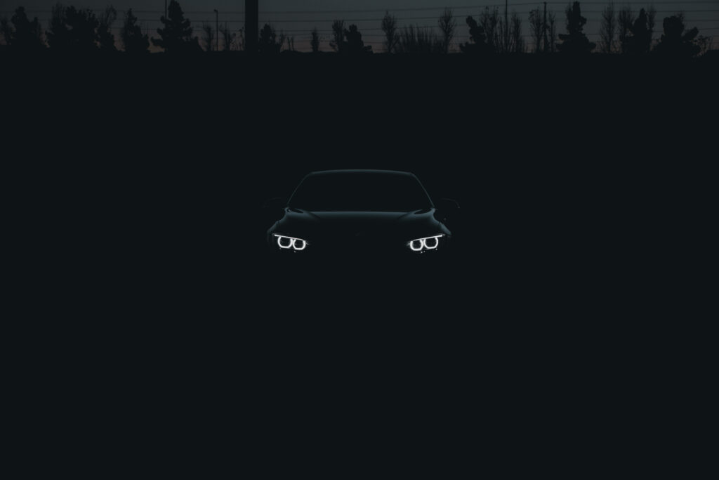 Enigmatic Elegance: The Alluring Silhouette of a Covert Black BMW Against an Obsidian Canvas Wallpaper