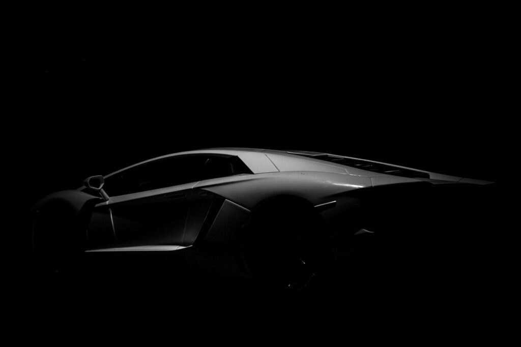 Midnight Speed: Enthralling Black Sports Car Wallpaper