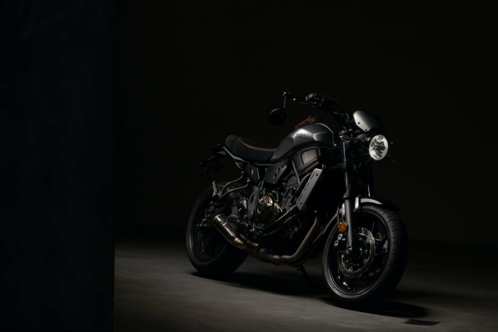 Matte black Yamaha XSR700 motorcycle with low-key lighting high contrast modern retro design wallpaper