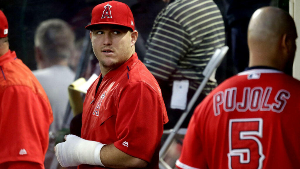 Mike Trout Sidelines Wallpaper: Red Jersey & Hand Injury Reflection